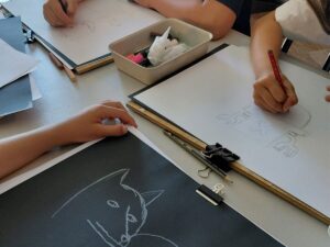 children focusing on an open-ended art project, building resilience instead of being a child scared to try new things.
